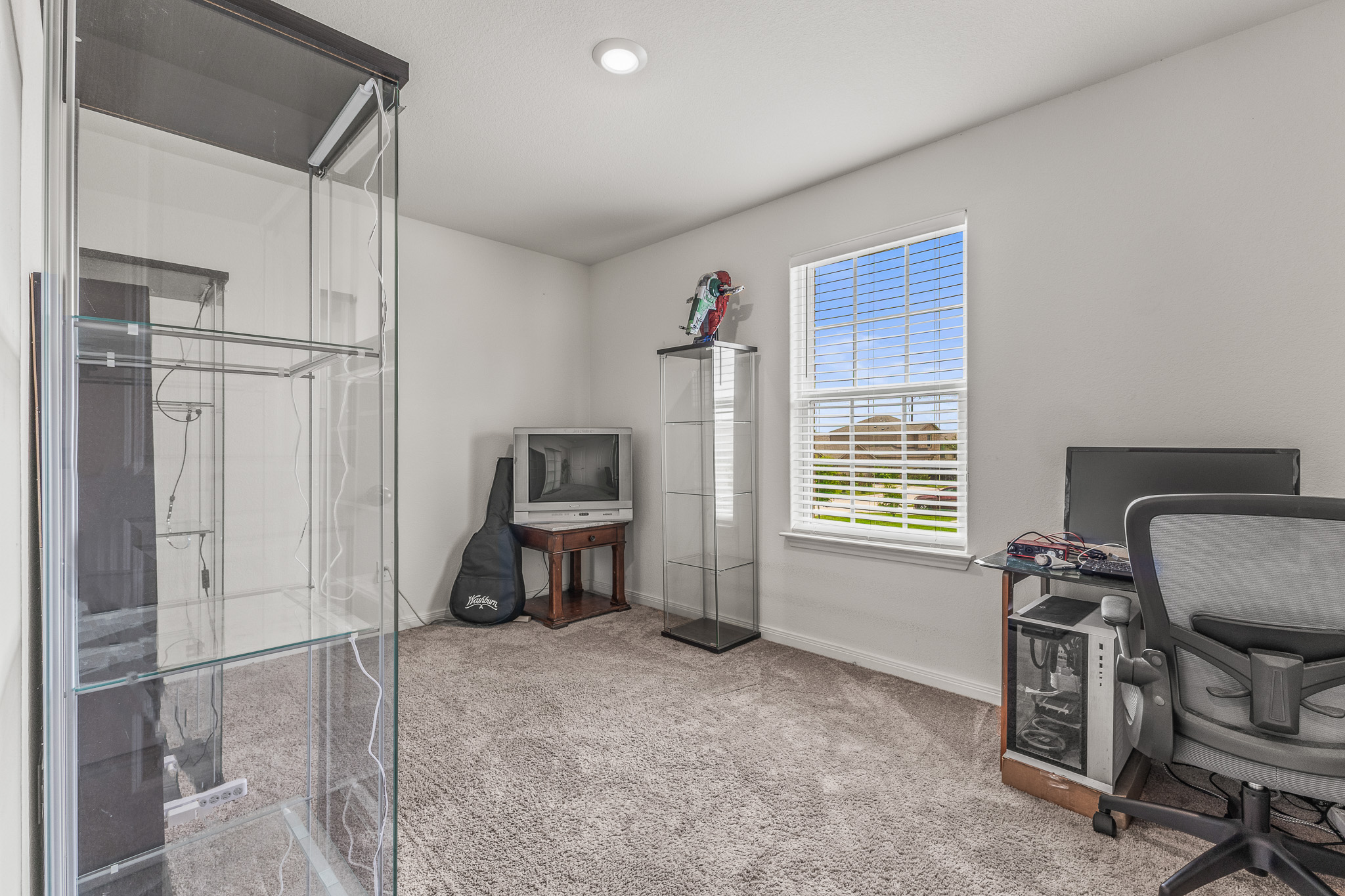 304 Hyacinth Way, Unit #7K Jarrell, TX 76537 - Photo 17 of 26 Well-lit room provides a flexible space for diverse activities and personal touches.