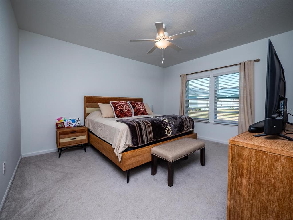 9052 Southwest 58th Circle Ocala, FL 34476 - Photo 15 of 19 a bedroom with a bed and a flat screen tv