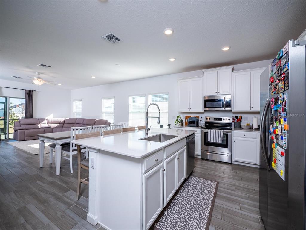 9052 Southwest 58th Circle Ocala, FL 34476 - Photo 3 of 19 a kitchen with appliances a sink and cabinets