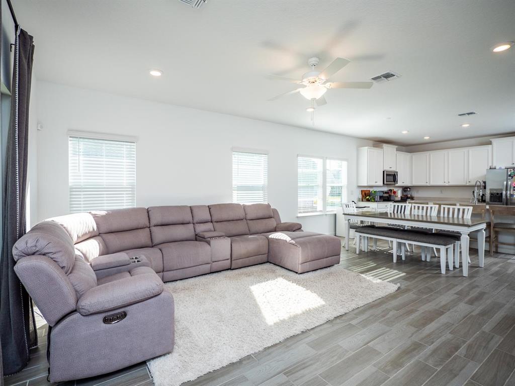 9052 Southwest 58th Circle Ocala, FL 34476 - Photo 6 of 19 a living room with furniture and kitchen view