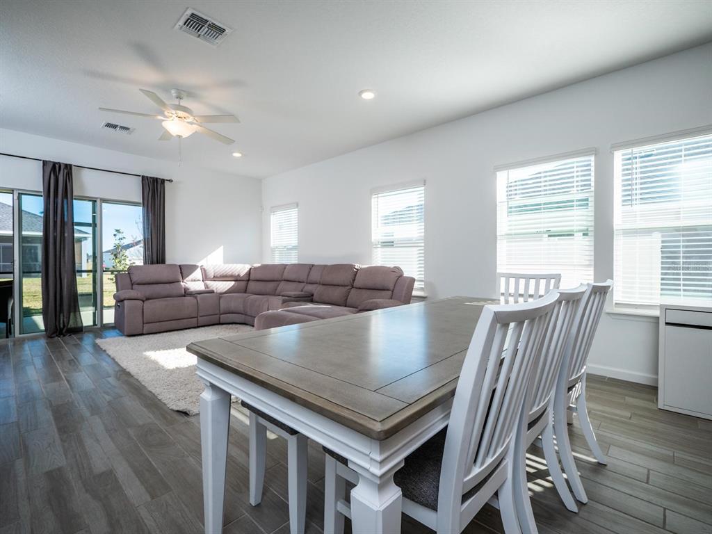 9052 Southwest 58th Circle Ocala, FL 34476 - Photo 8 of 19 a view of a dining room with furniture and wooden floor