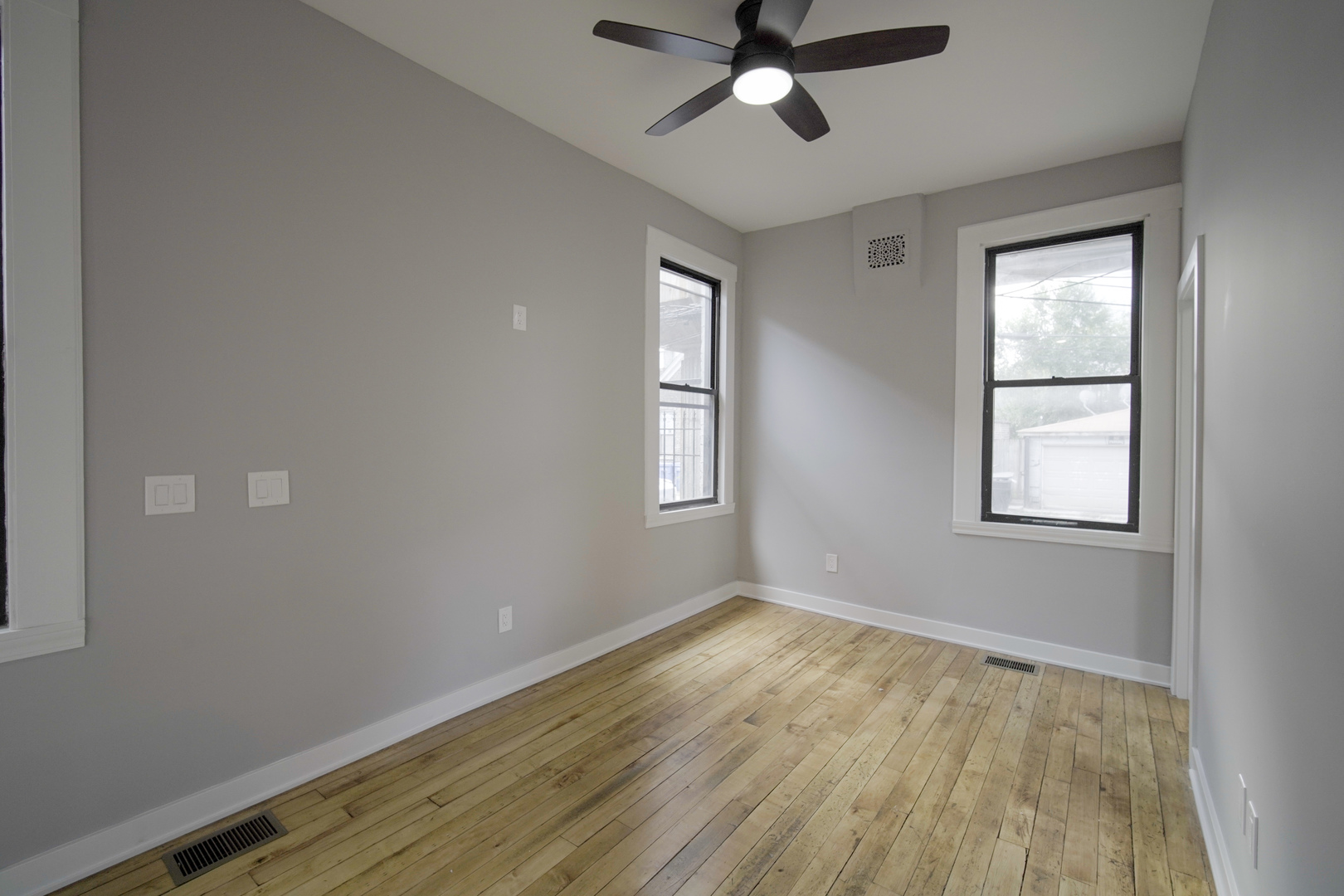2235 West Cullerton Street Chicago, IL 60608 - Photo 11 of 15 a view of an empty room with wooden floor and a window