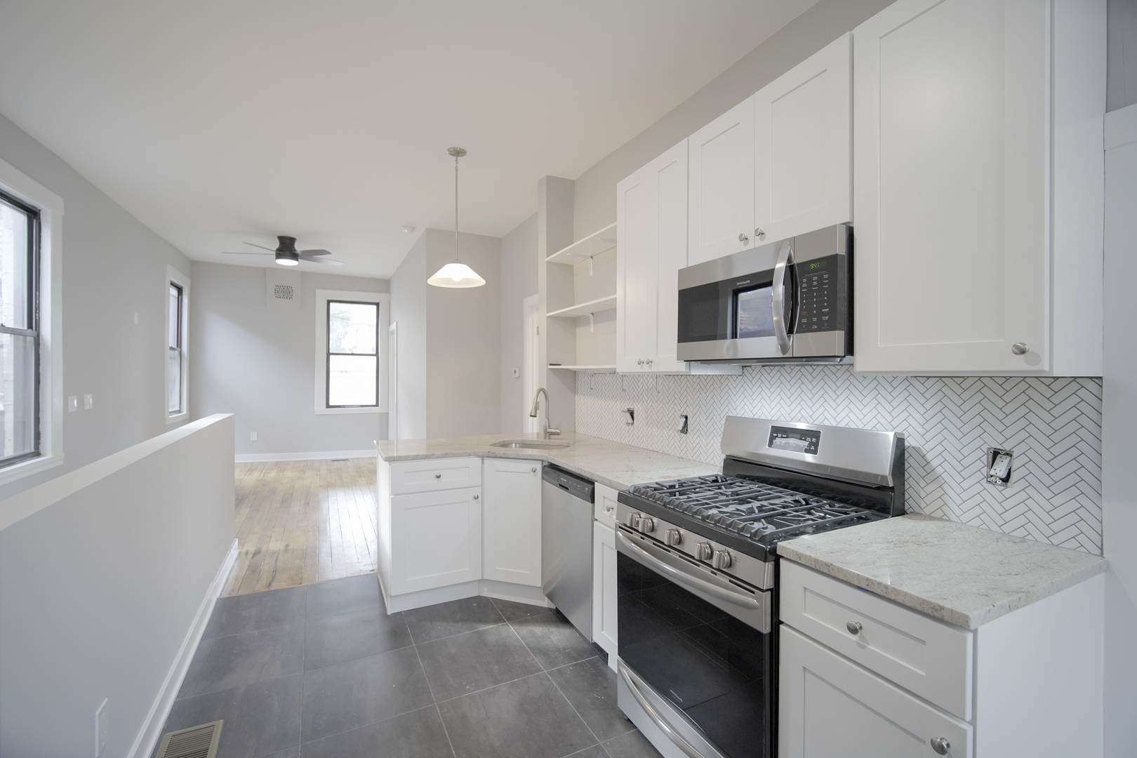 2235 West Cullerton Street Chicago, IL 60608 - Photo 12 of 15 a kitchen with stainless steel appliances white cabinets and stove top oven