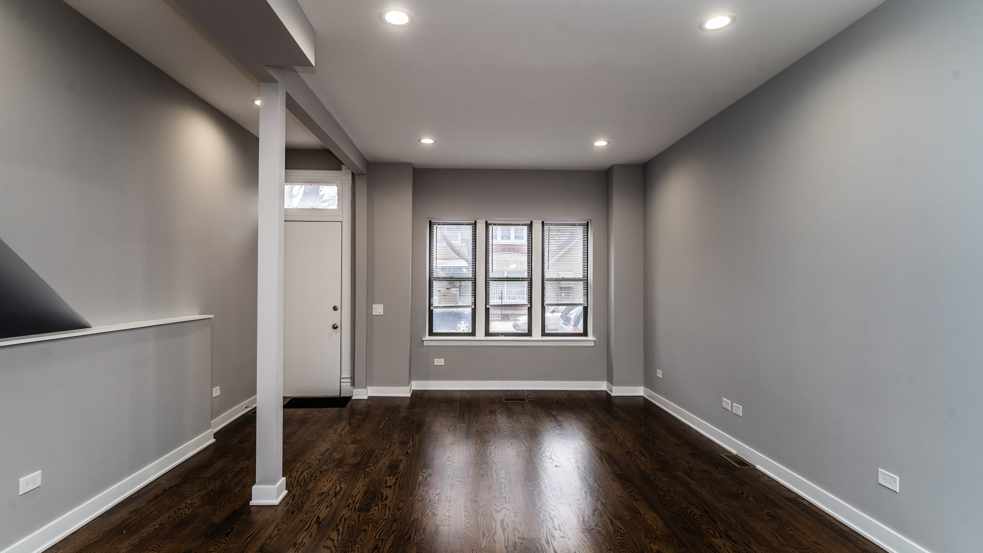2235 West Cullerton Street Chicago, IL 60608 - Photo 2 of 15 an empty room with wooden floor and windows with curtains