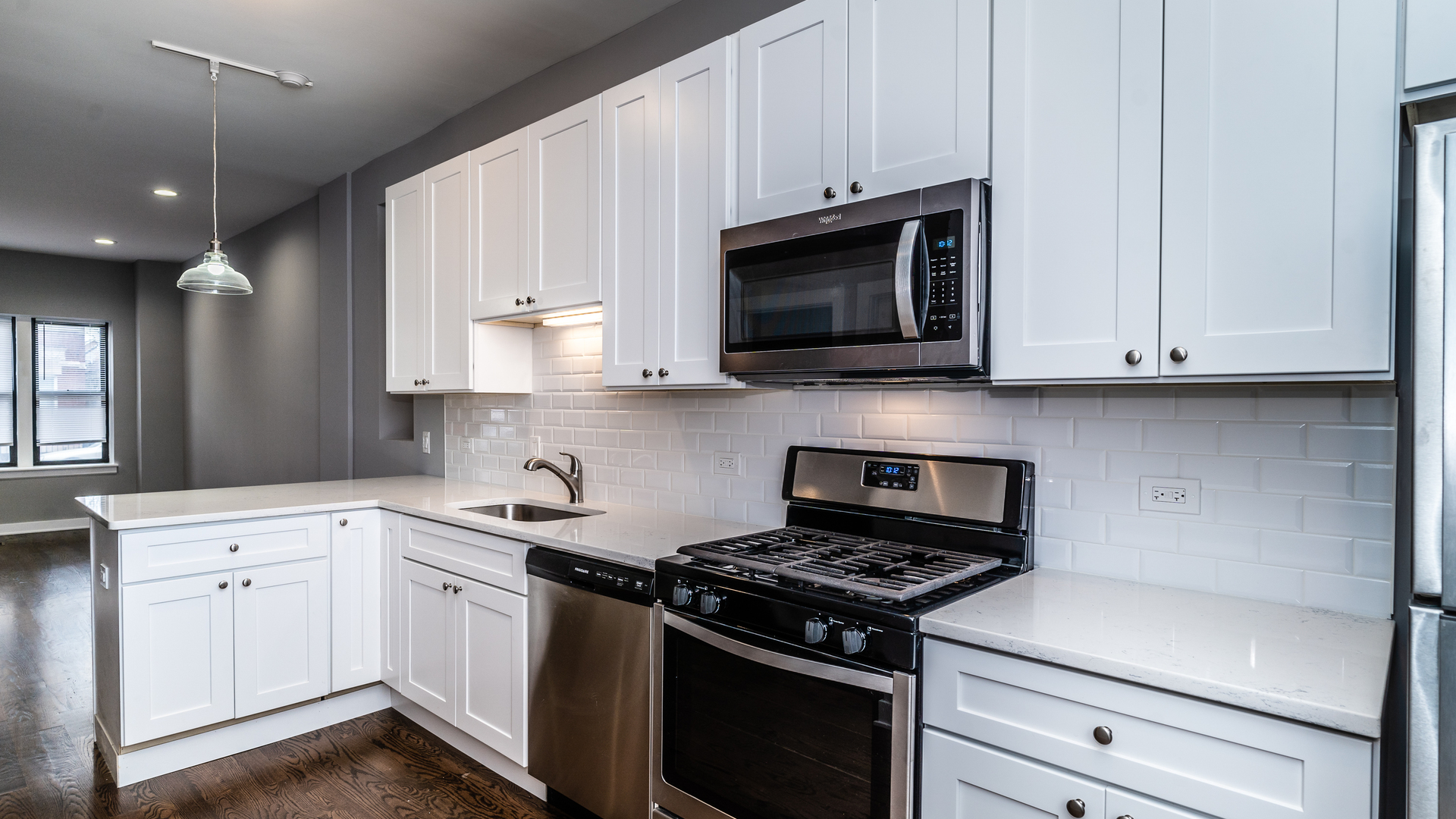 2235 West Cullerton Street Chicago, IL 60608 - Photo 5 of 15 a kitchen with granite countertop white cabinets and stainless steel appliances