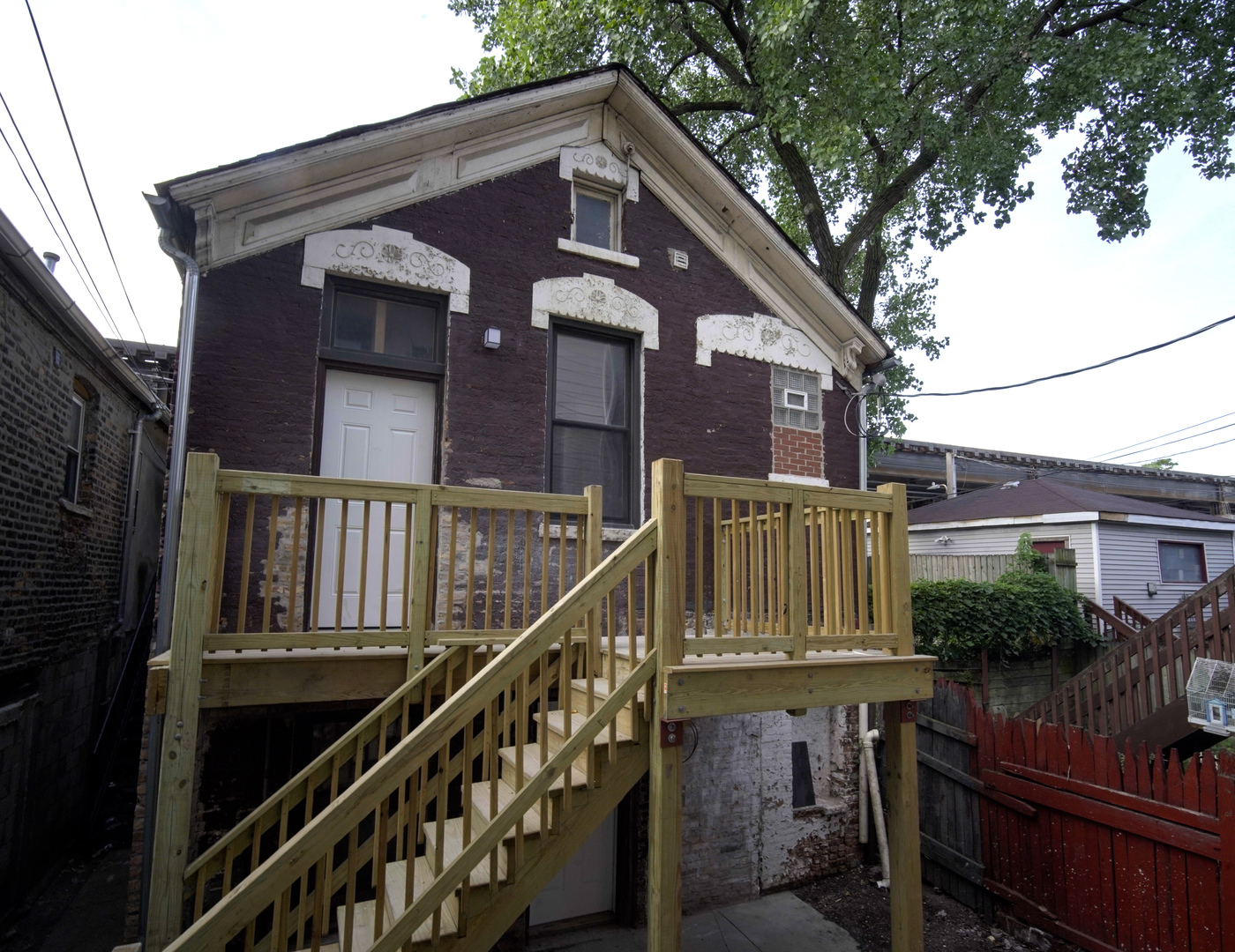 2235 West Cullerton Street Chicago, IL 60608 - Photo 10 of 15 a view of a house with wooden fence and windows