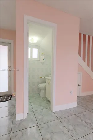 a bathroom with a sink a toilet and a window