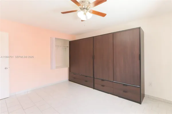 an empty room with a ceiling fan