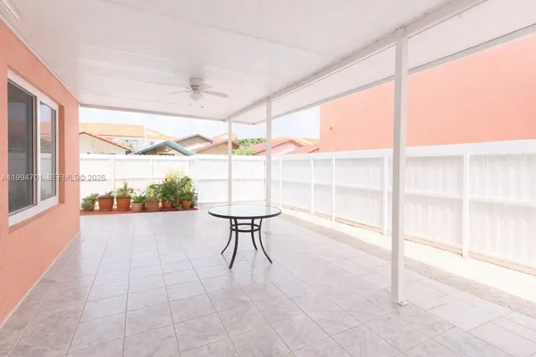 a spacious bedroom with a large bed and a chandelier