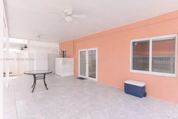 a room with a bed and a large window