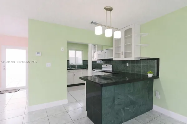 a view of a living room and kitchen