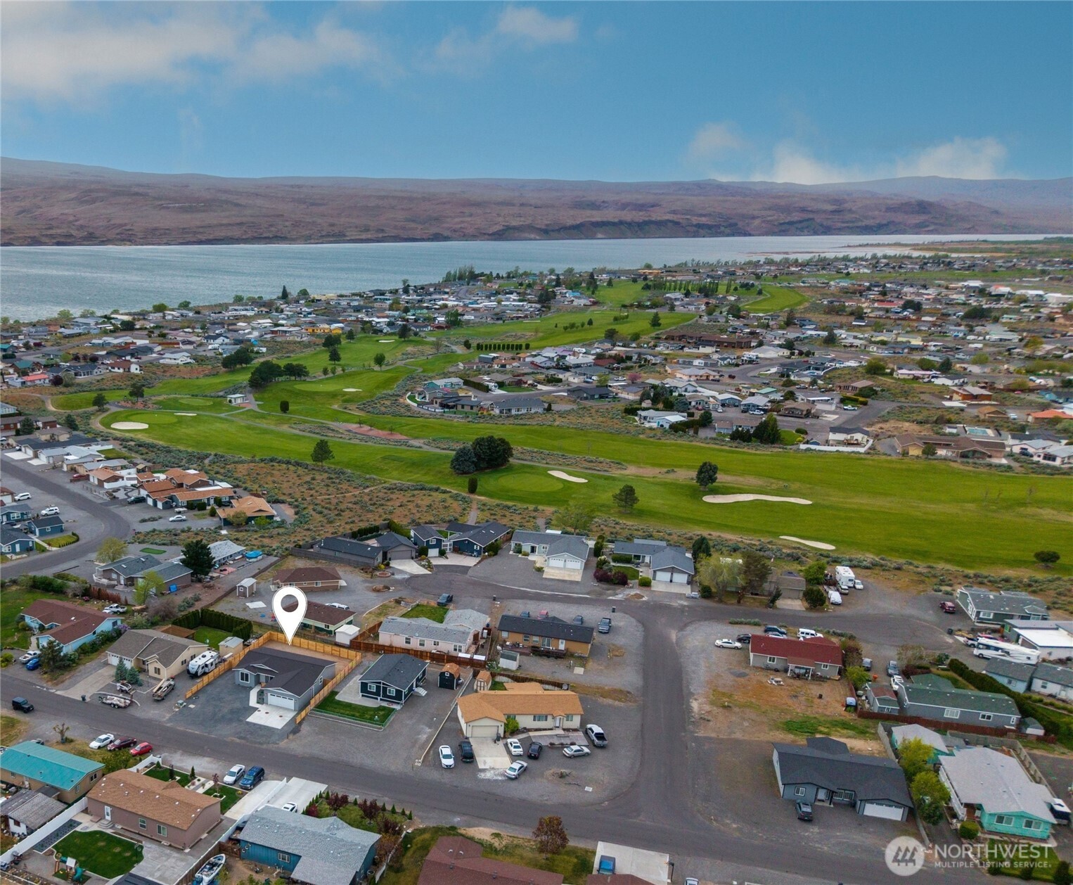 334 Spring Circle Mattawa, WA 99349 - Photo 32 of 40 a view of a city with lots of residential buildings and ocean view in back