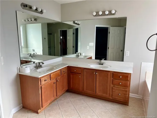 a bathroom with a sink double vanity and a mirror