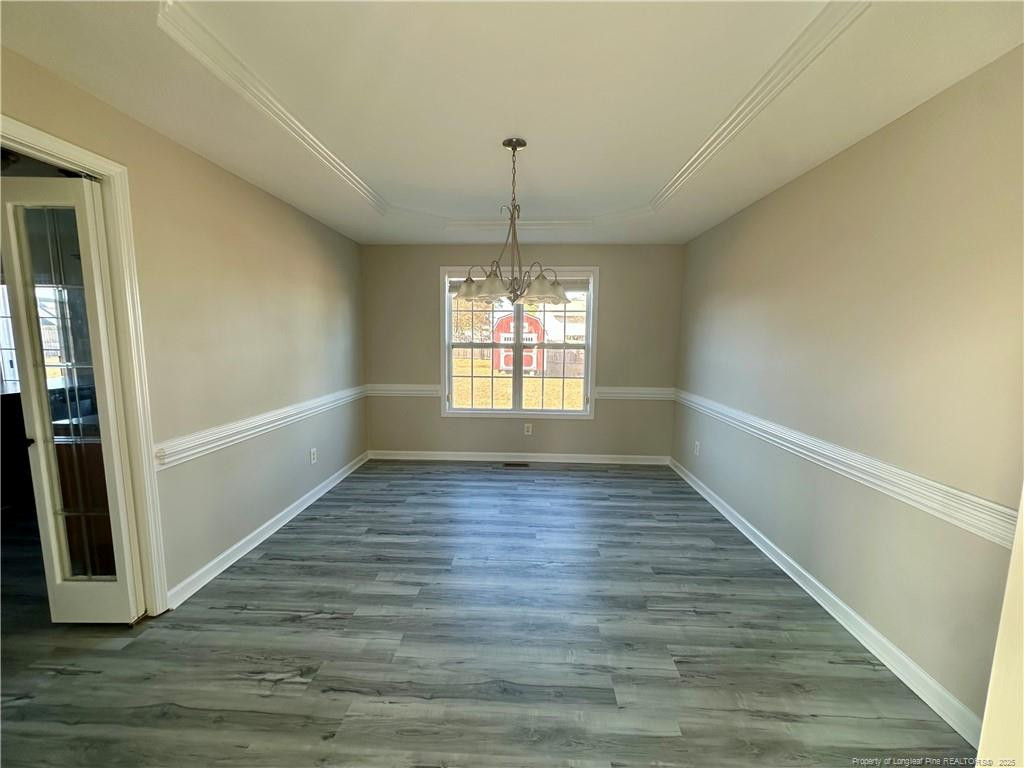 11 Lattimore Road Cameron, NC 28326 - Photo 6 of 18 a view of an empty room with wooden floor and a window