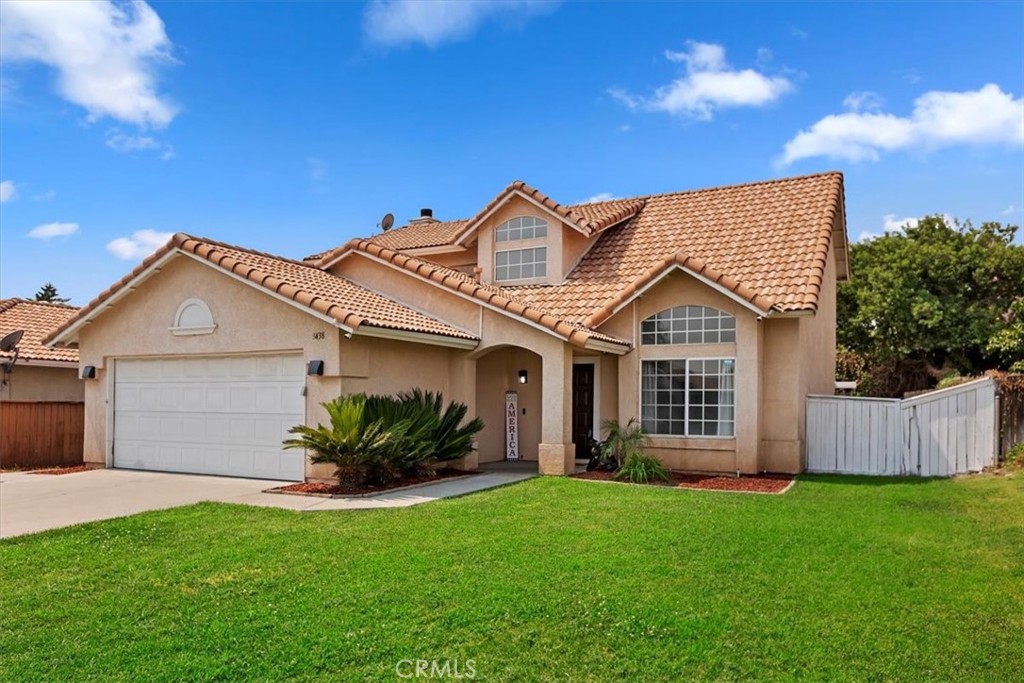 3438 North Plum Tree Avenue Rialto, CA 92377 - Photo 1 of 1 a front view of a house with a garden