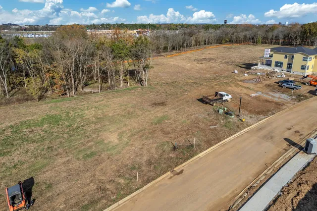 a view of a lake with beach and city