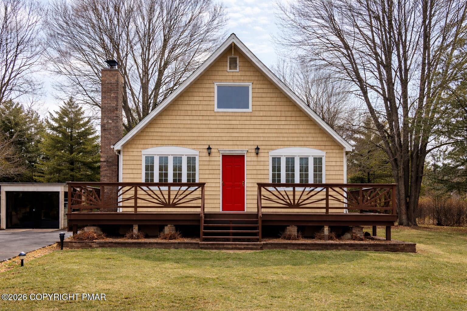 a front view of a house with a yard balcony