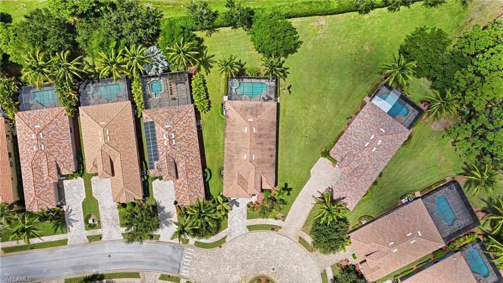 9479 Piacere Way Naples, FL 34113 - Photo 44 of 48 Tile roofs, private swimming pools, screened pool enclosures, paver driveways, and mature landscaping