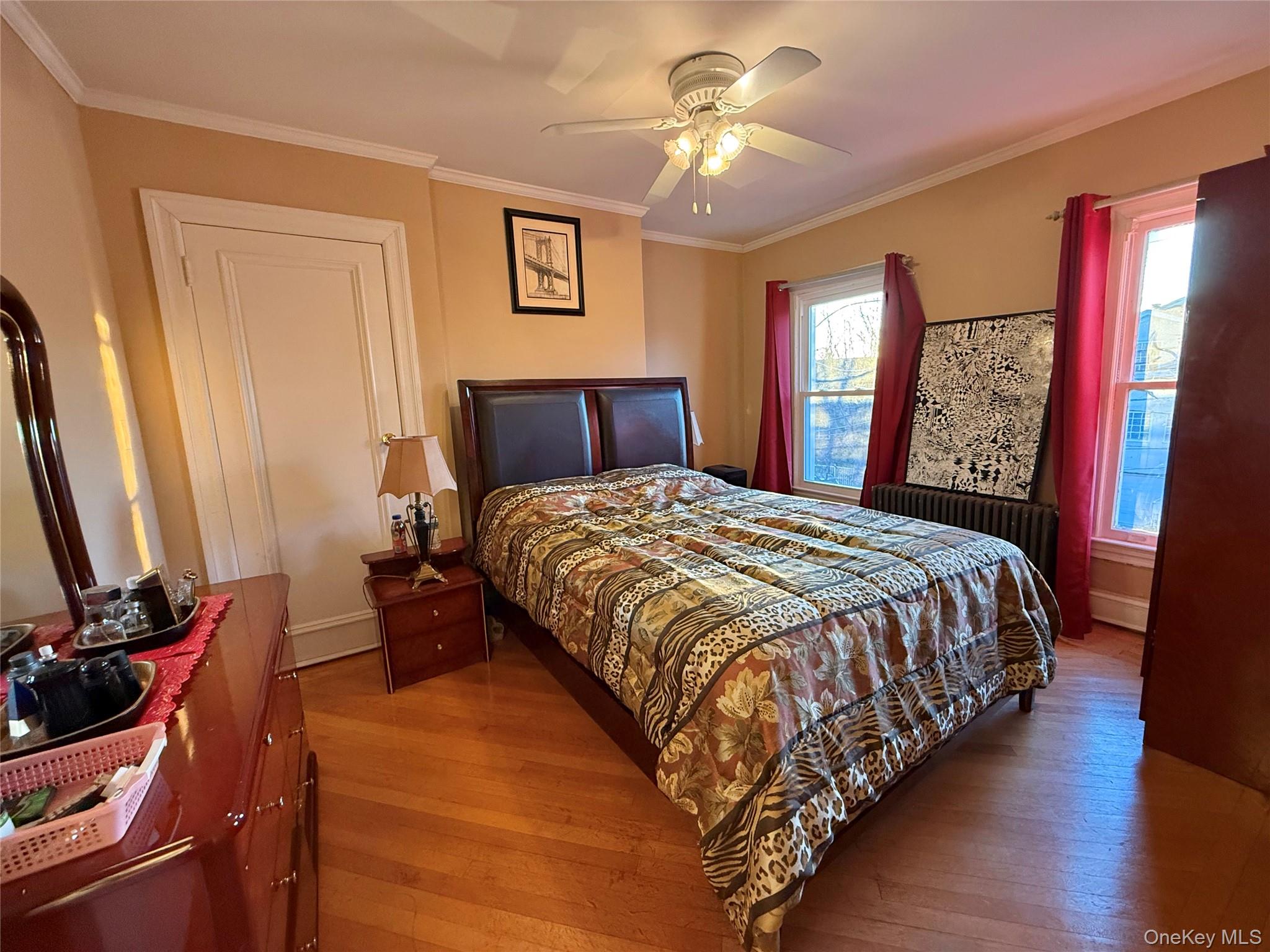 54-05 68th Street Queens, NY 11378 - Photo 16 of 47 Bedroom with ornamental molding, dark wood finished floors, and ceiling fan