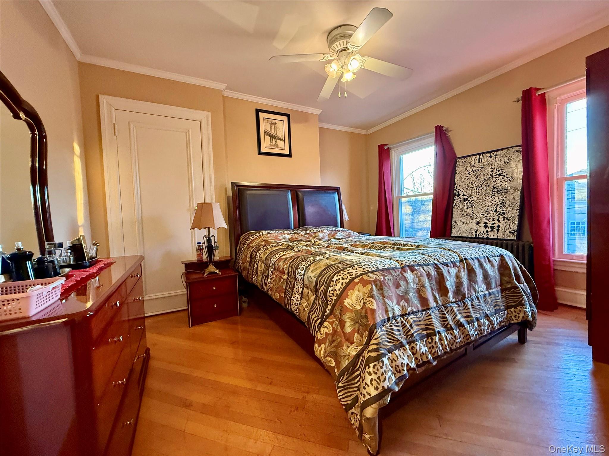 54-05 68th Street Queens, NY 11378 - Photo 17 of 47 Bedroom with crown molding, light wood finished floors, and ceiling fan