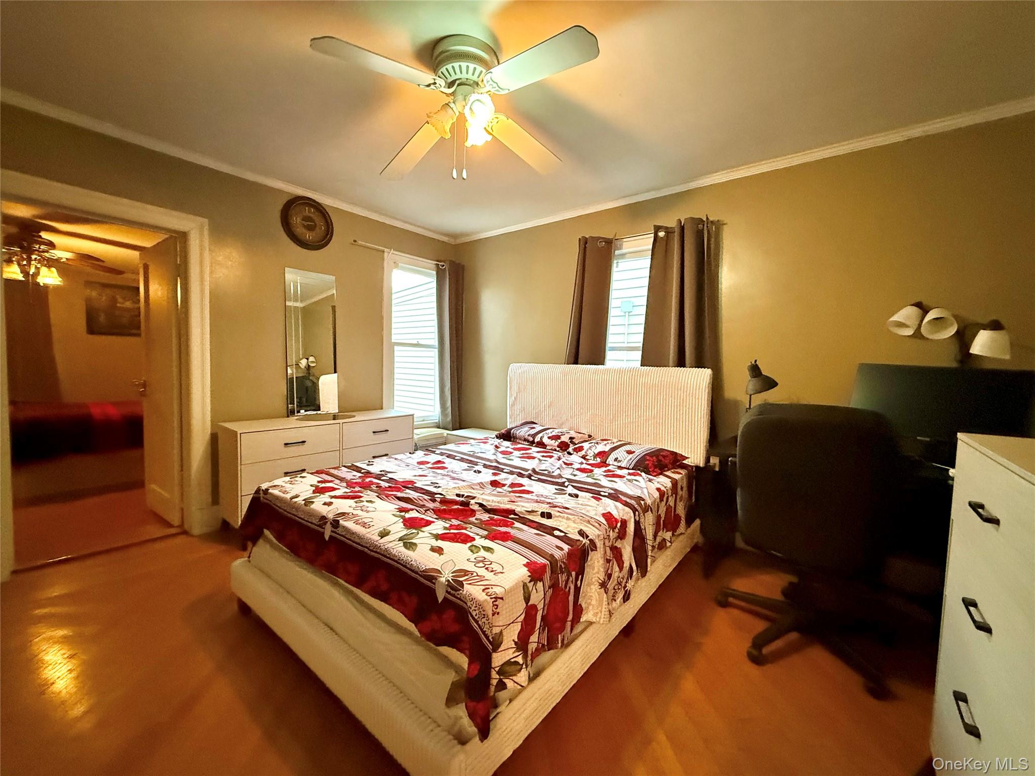 54-05 68th Street Queens, NY 11378 - Photo 18 of 47 Second bedroom featuring crown molding and a ceiling fan
