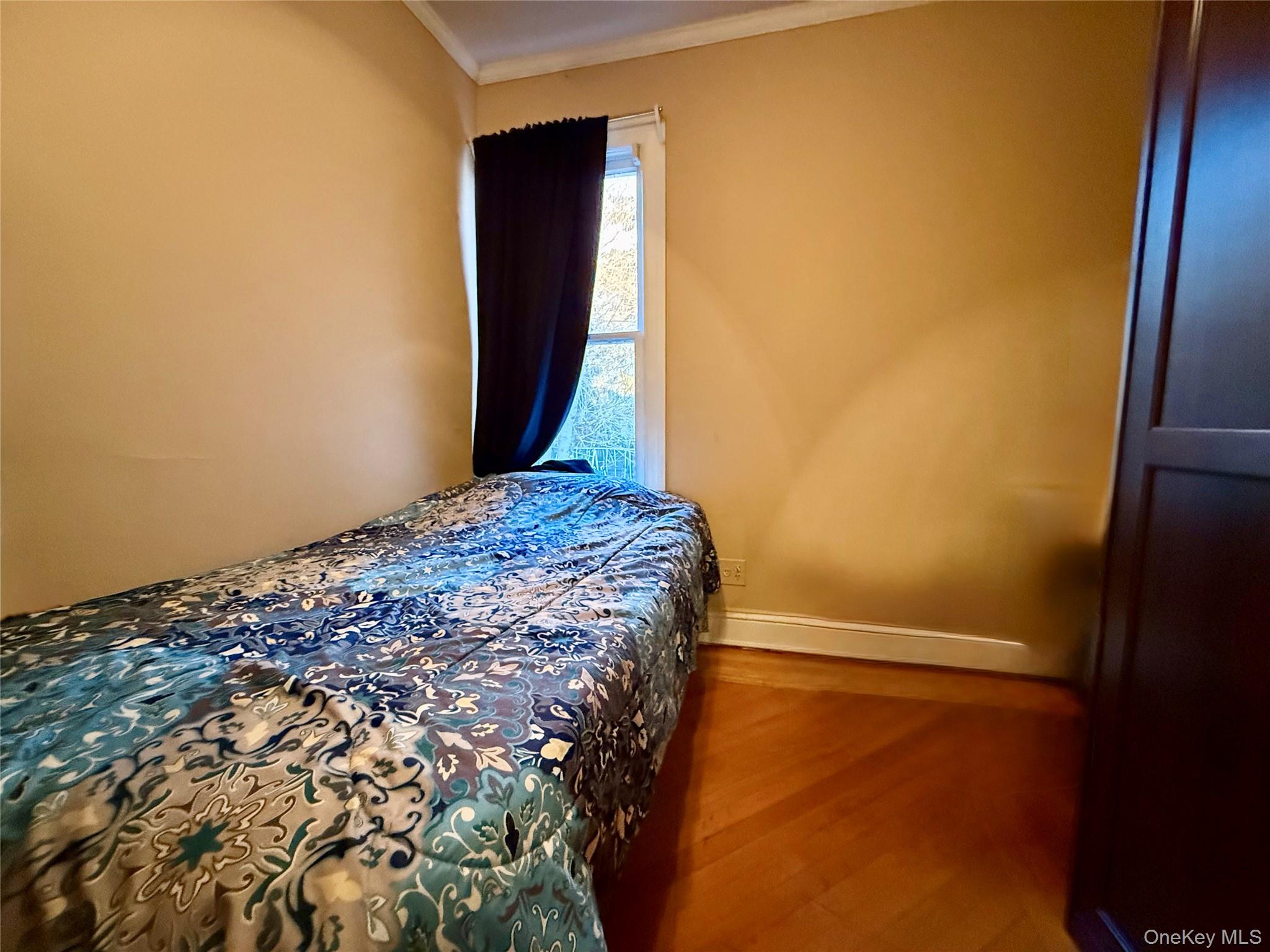 54-05 68th Street Queens, NY 11378 - Photo 21 of 47 Fourth bedroom featuring wood finished floors and crown molding