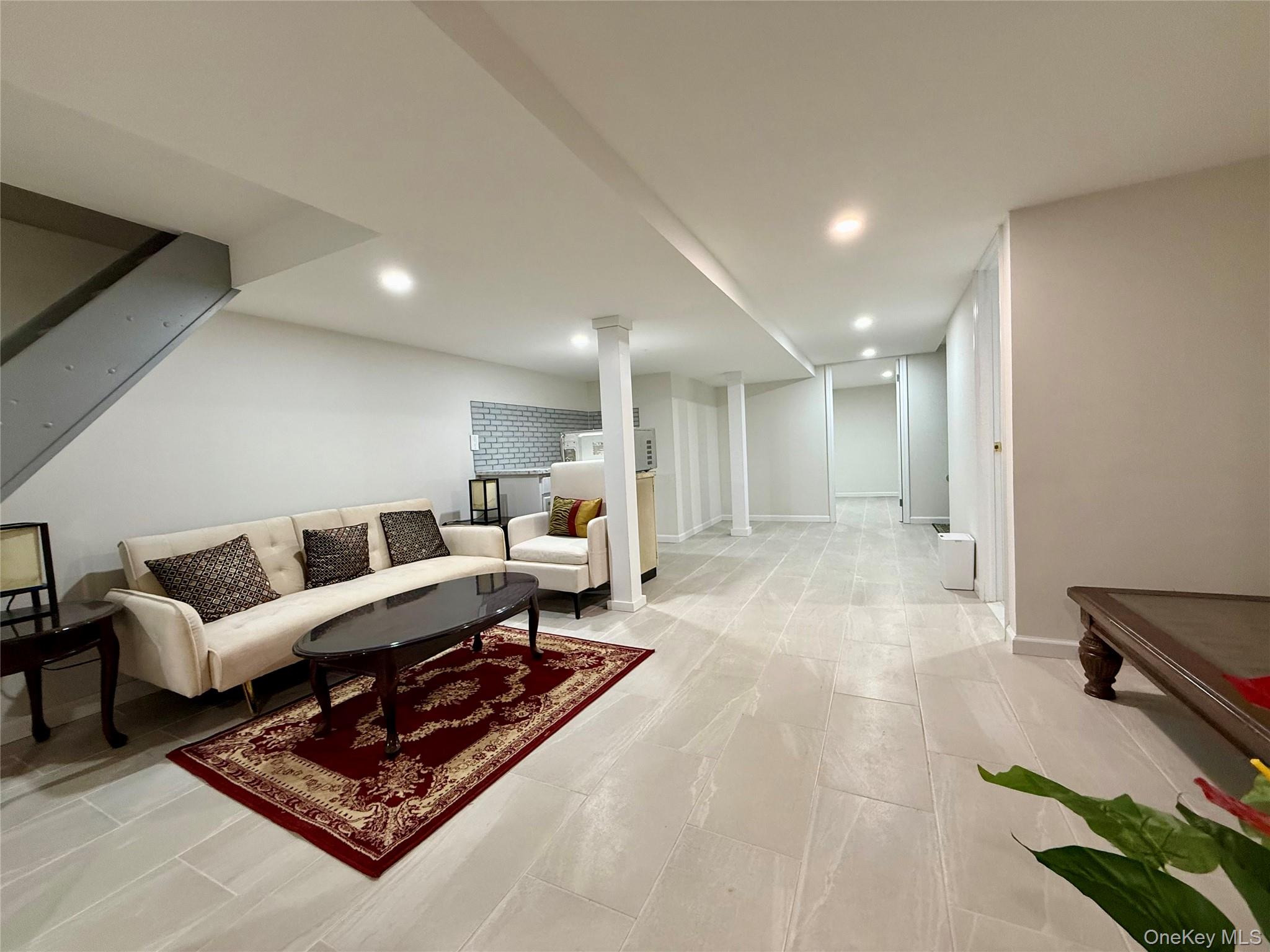 54-05 68th Street Queens, NY 11378 - Photo 26 of 47 Basement with open space fully renovated with tiled floors and recessed lighting