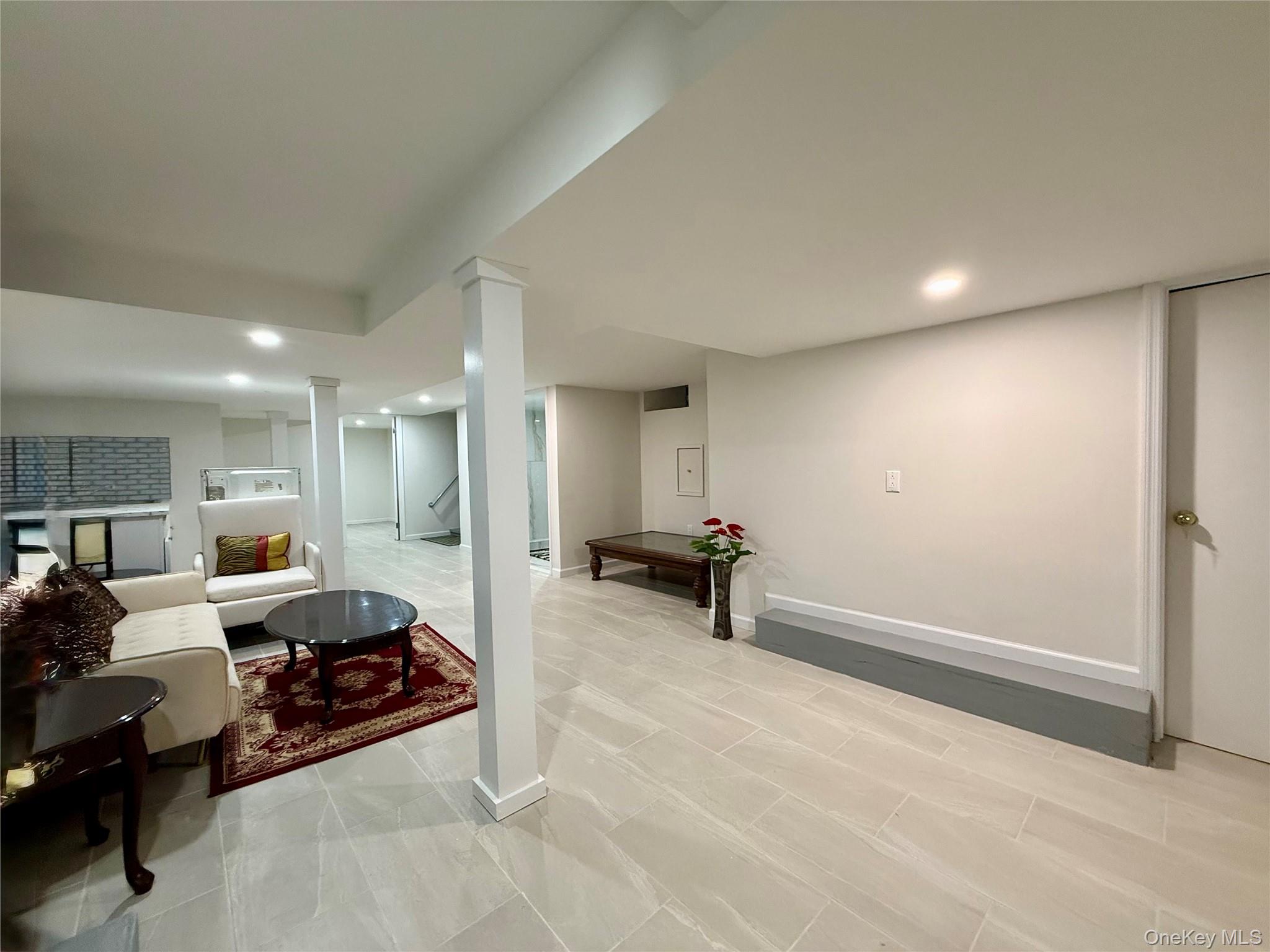 54-05 68th Street Queens, NY 11378 - Photo 28 of 47 Basement with open space fully renovated with tiled floors and recessed lighting