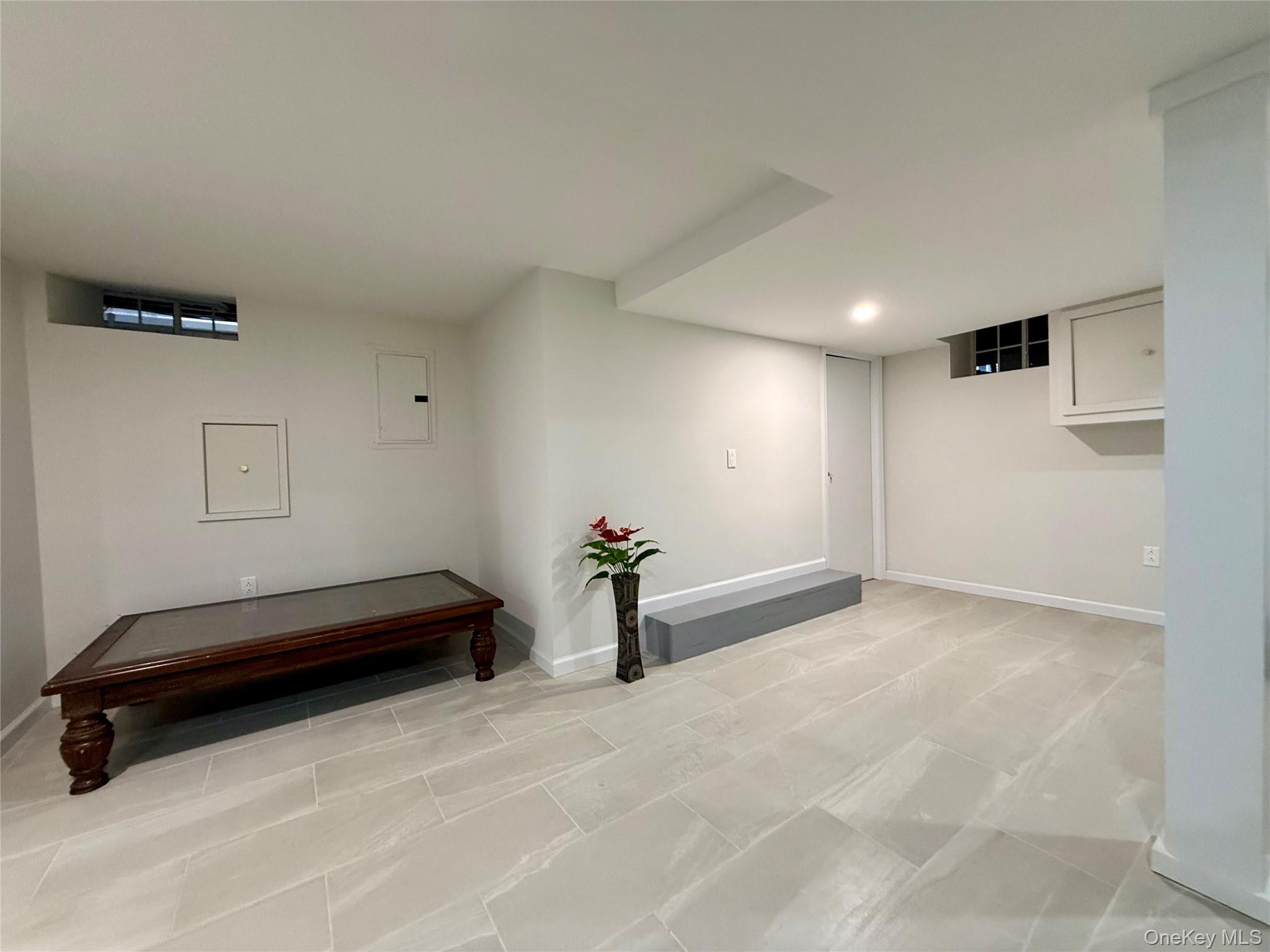54-05 68th Street Queens, NY 11378 - Photo 29 of 47 Basement with open space fully renovated with tiled floors and recessed lighting
