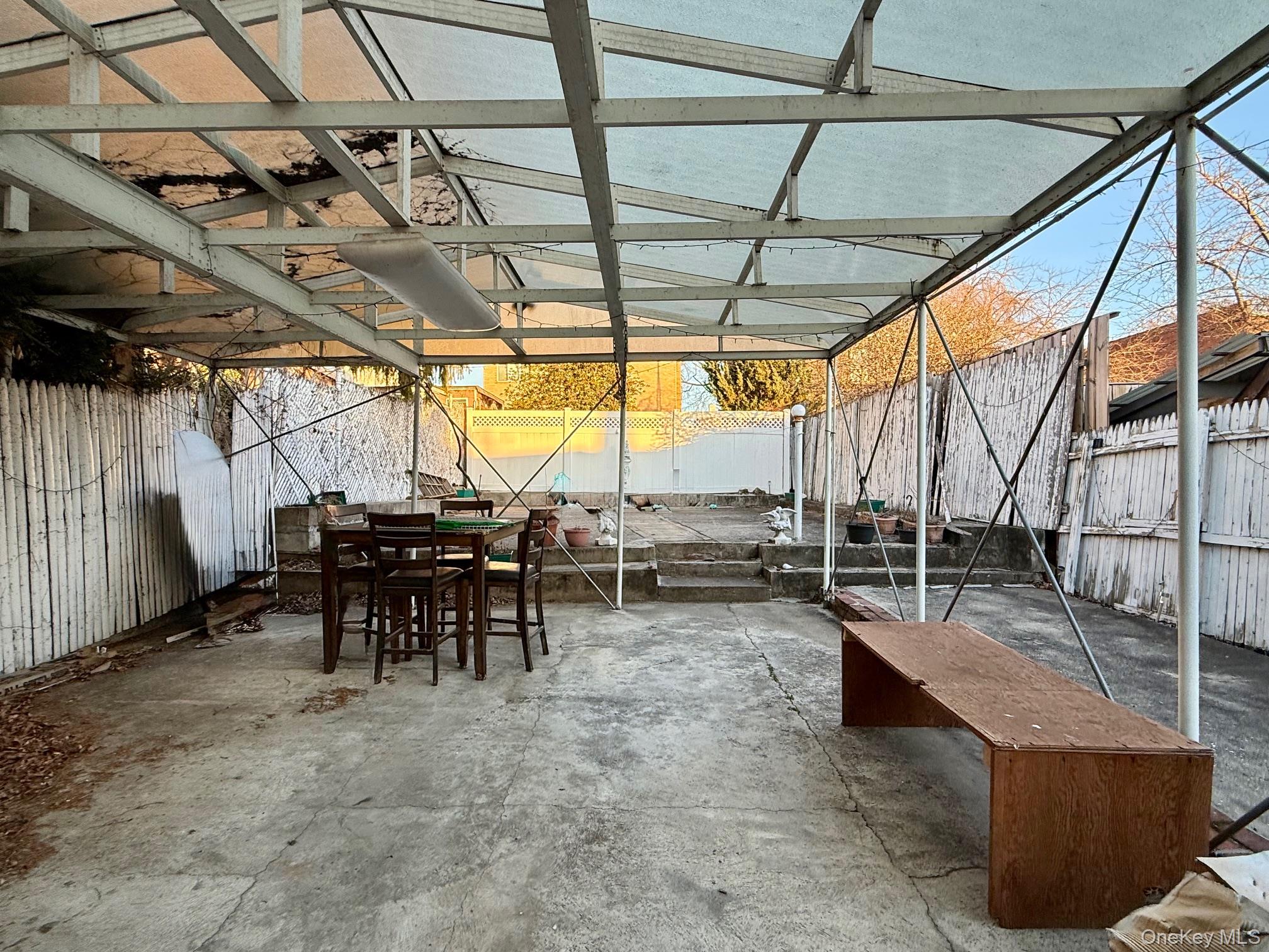 54-05 68th Street Queens, NY 11378 - Photo 41 of 47 Fenced backyard featuring a patio area and outdoor dining area