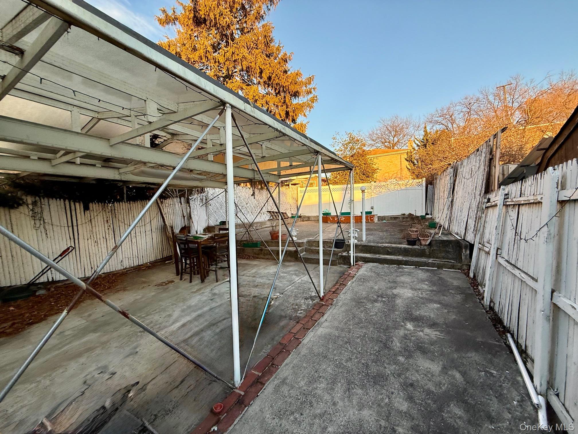 54-05 68th Street Queens, NY 11378 - Photo 42 of 47 Fenced backyard featuring a patio