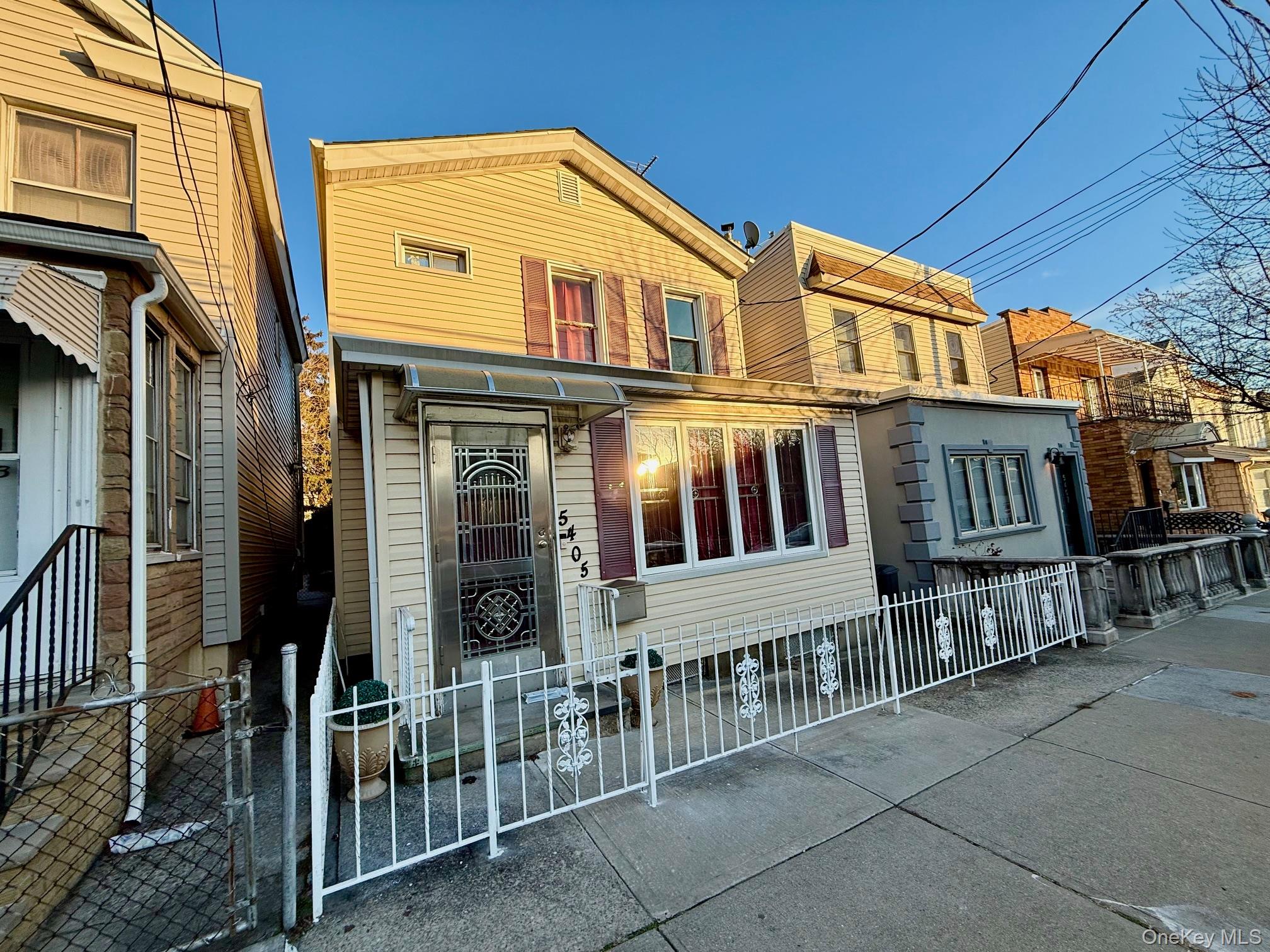 54-05 68th Street Queens, NY 11378 - Photo 46 of 47 View of front of home with a gate and a fenced front yard
