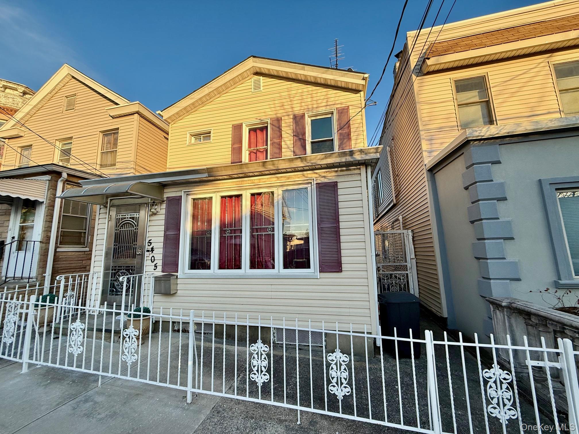 54-05 68th Street Queens, NY 11378 - Photo 47 of 47 Traditional-style house featuring a fenced front yard