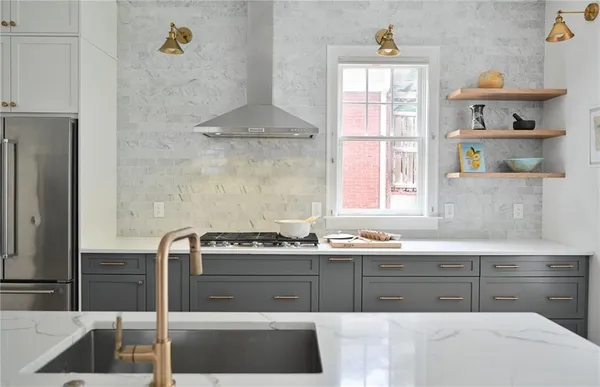 a kitchen with a sink a stove and cabinets