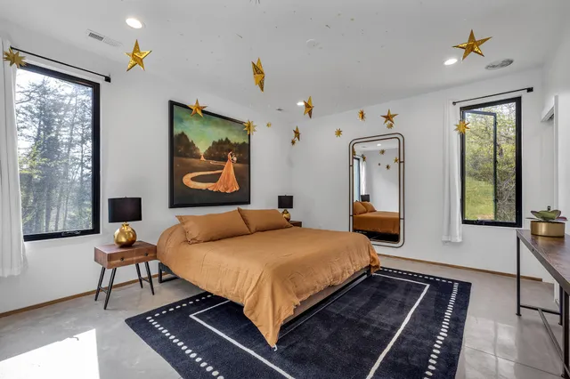 a bedroom with a bed and wooden floor