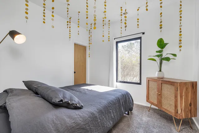 a bedroom with a bed and a window