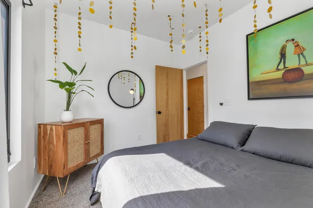 a bedroom with a bed and a chandelier