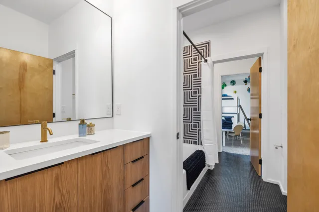 a bathroom with a sink a toilet and a mirror