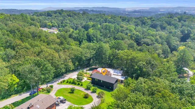 an aerial view of a house with a yard and lake view