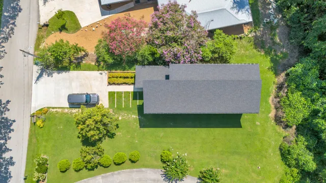 an aerial view of a house with a yard