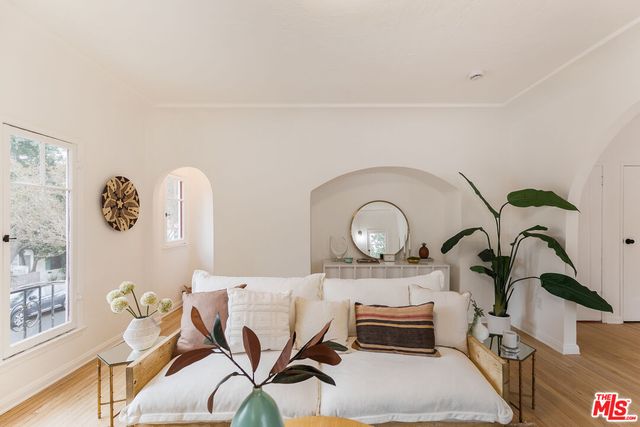 a living room with furniture fireplace and potted plant