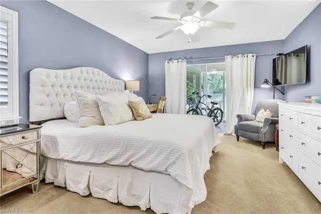 a bedroom with a bed and flat screen tv