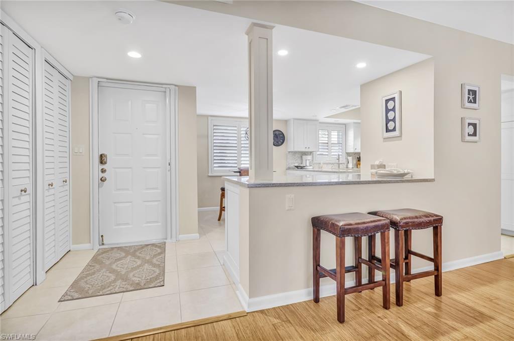 3200 Binnacle Drive, Unit D3 Naples, FL 34103 - Photo 2 of 25 a kitchen with granite countertop a table and chairs
