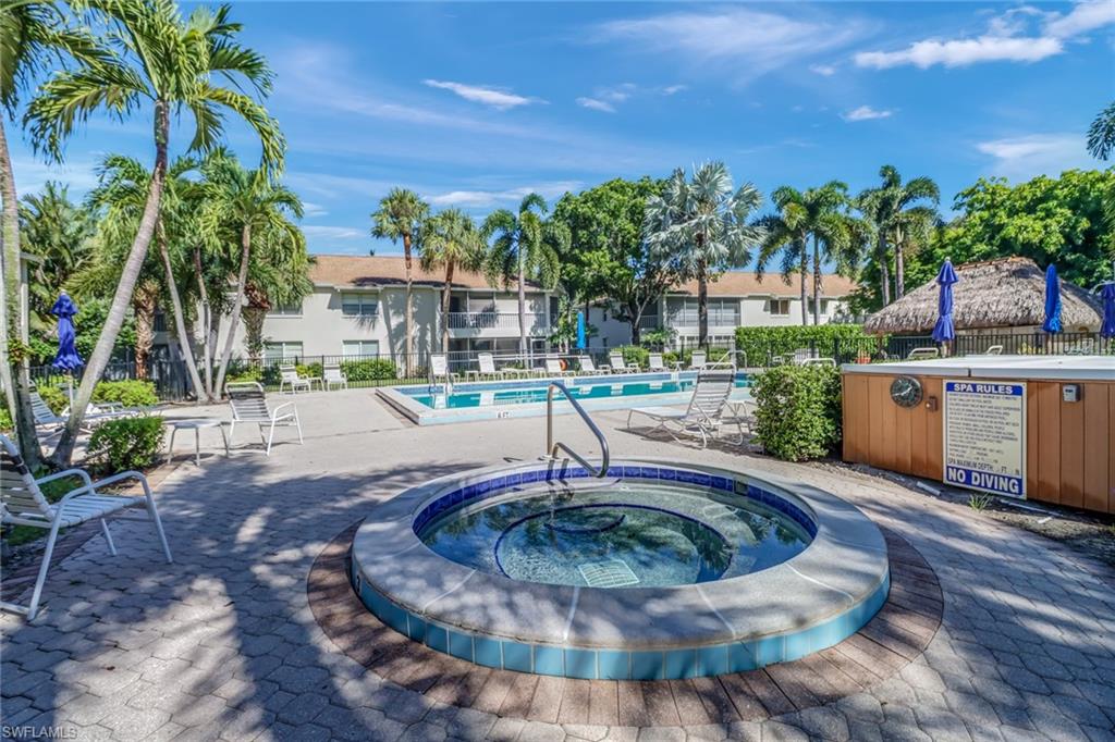3200 Binnacle Drive, Unit D3 Naples, FL 34103 - Photo 23 of 25 a view of a swimming pool with a patio