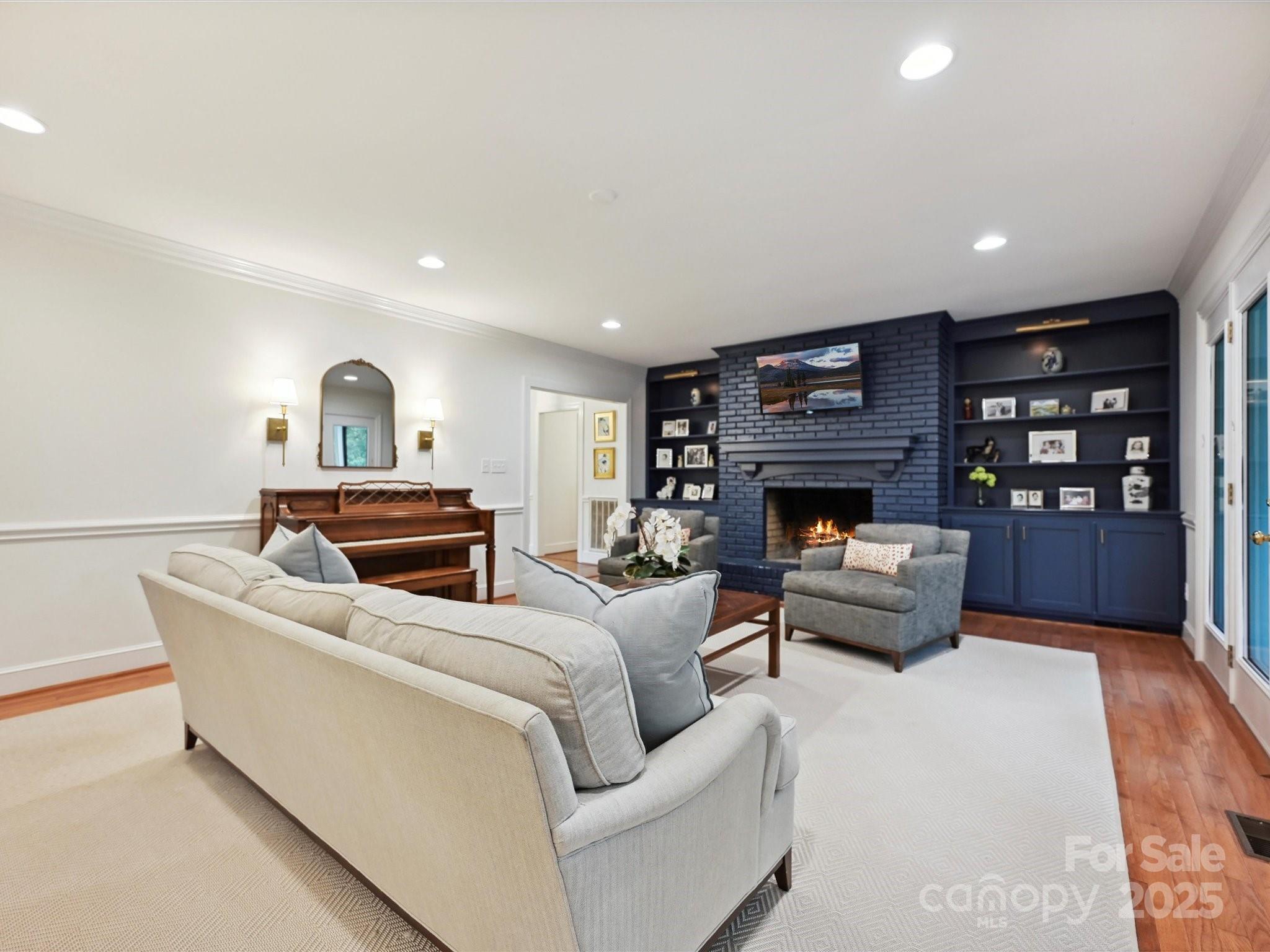 3610 Mill Pond Road Charlotte, NC 28226 - Photo 14 of 35 a living room with furniture a fireplace and a flat screen tv