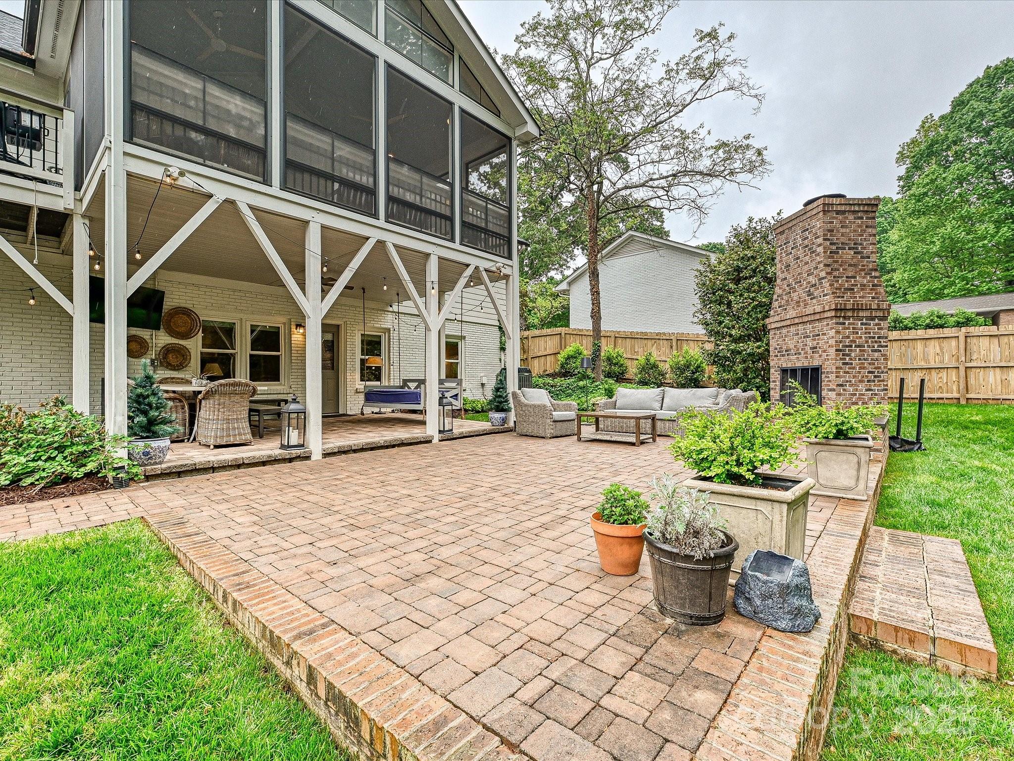 3610 Mill Pond Road Charlotte, NC 28226 - Photo 27 of 35 a view of a patio with table and chairs near a garden