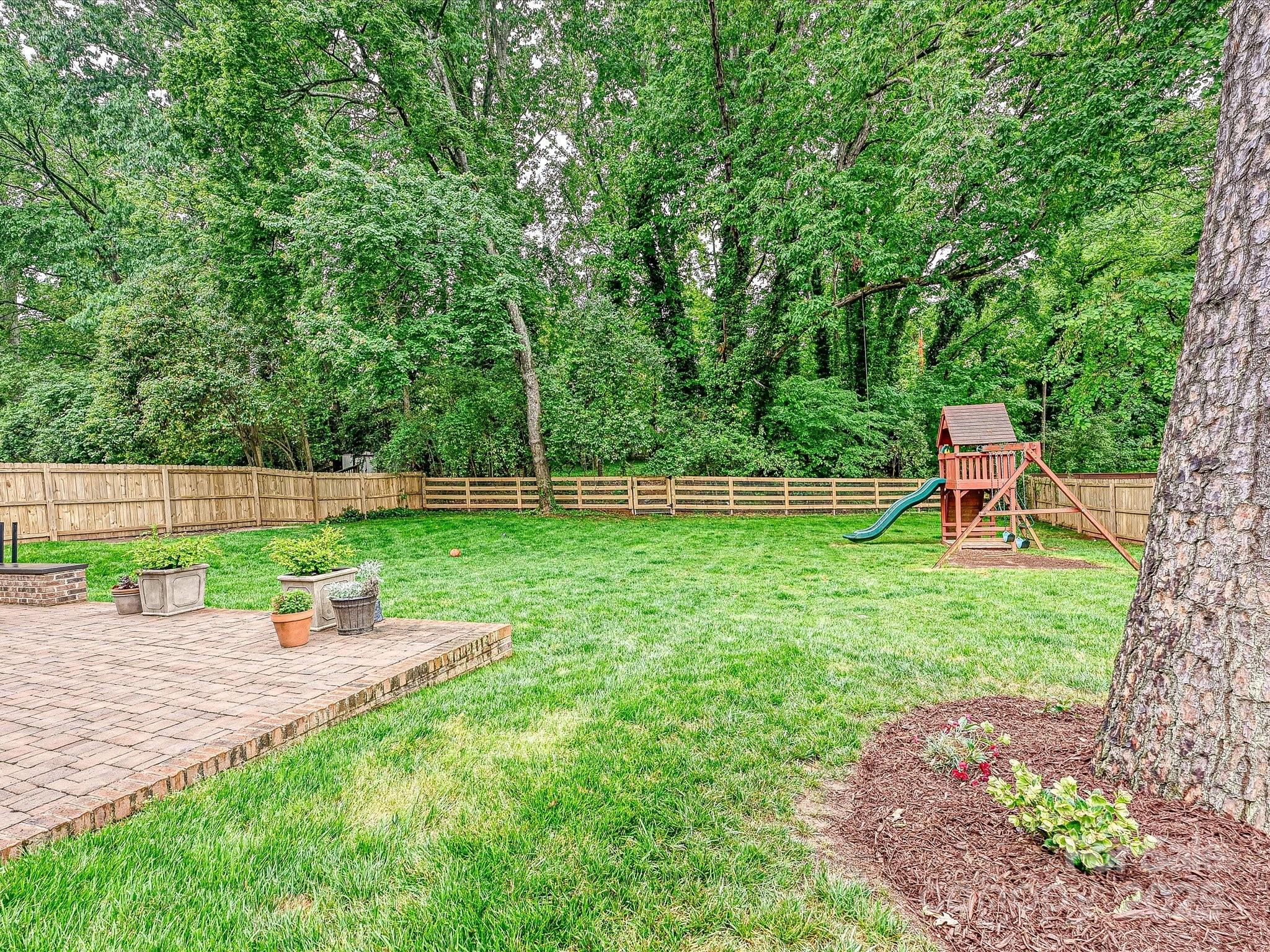 3610 Mill Pond Road Charlotte, NC 28226 - Photo 31 of 35 a backyard of a house with lots of green space and fountain