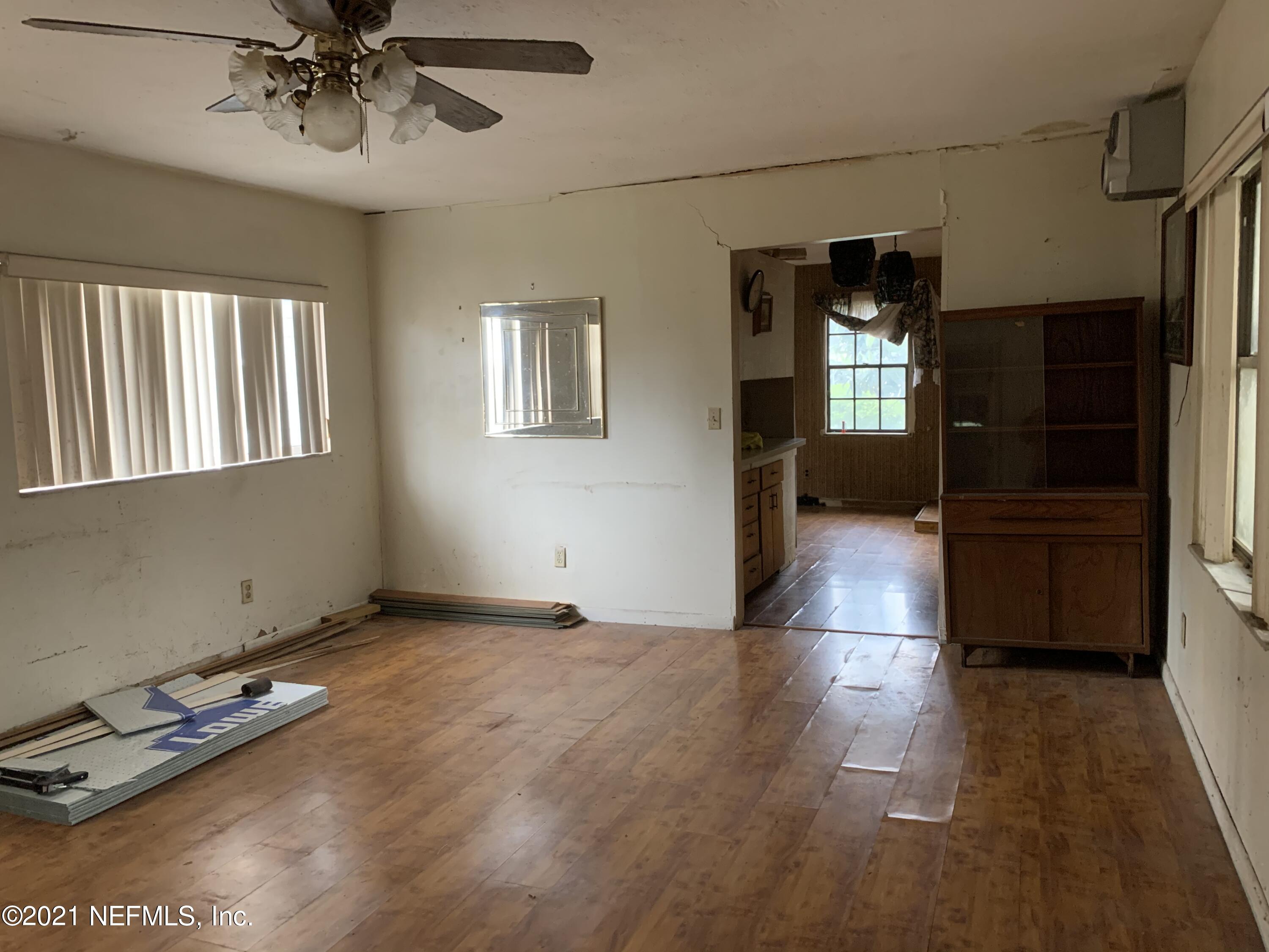 3852 Grant Road Jacksonville, FL 32207 - Photo 12 of 25 wooden floor in an empty room with a window