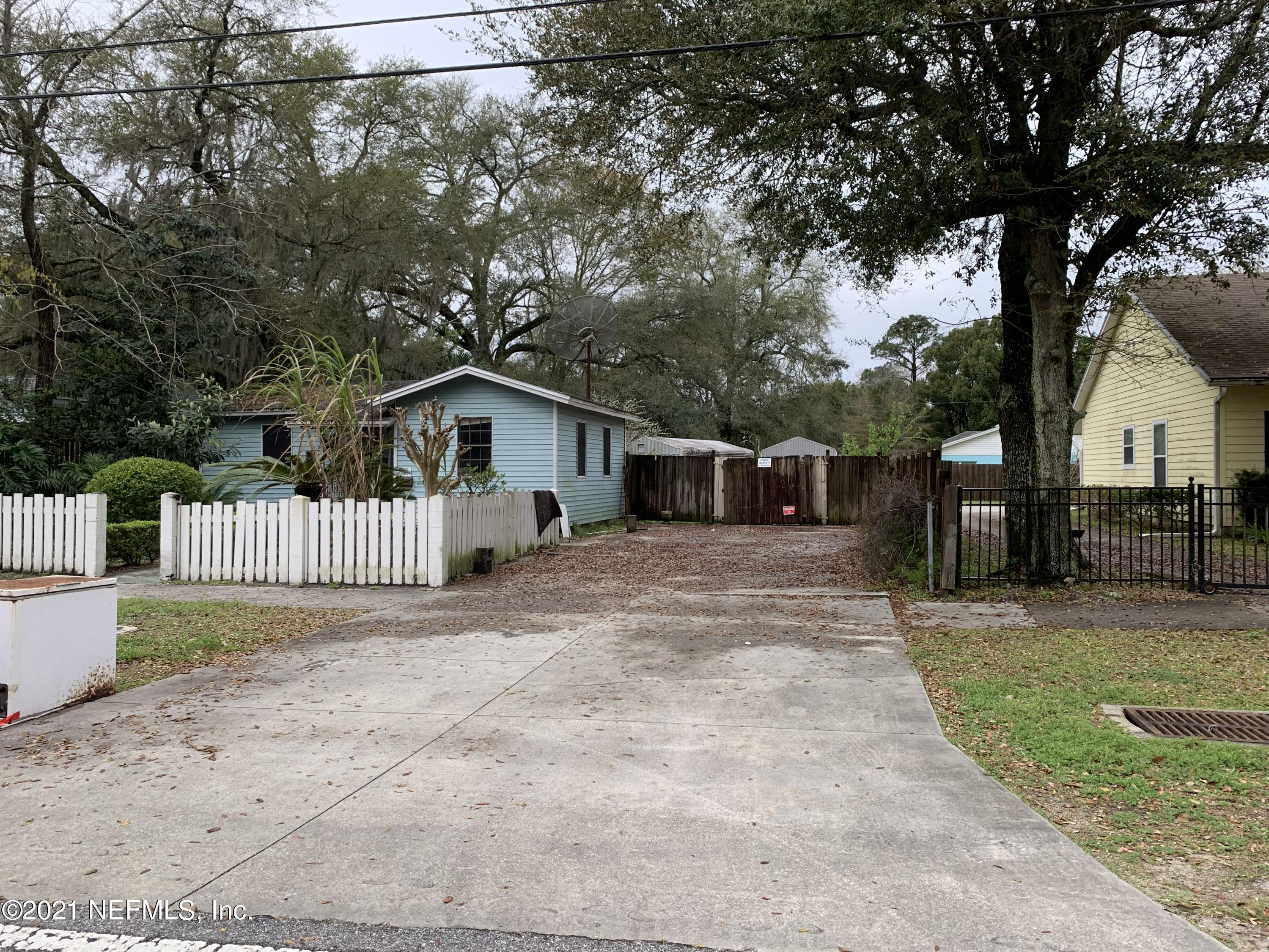 3852 Grant Road Jacksonville, FL 32207 - Photo 2 of 25 a view of a house with a yard and large trees