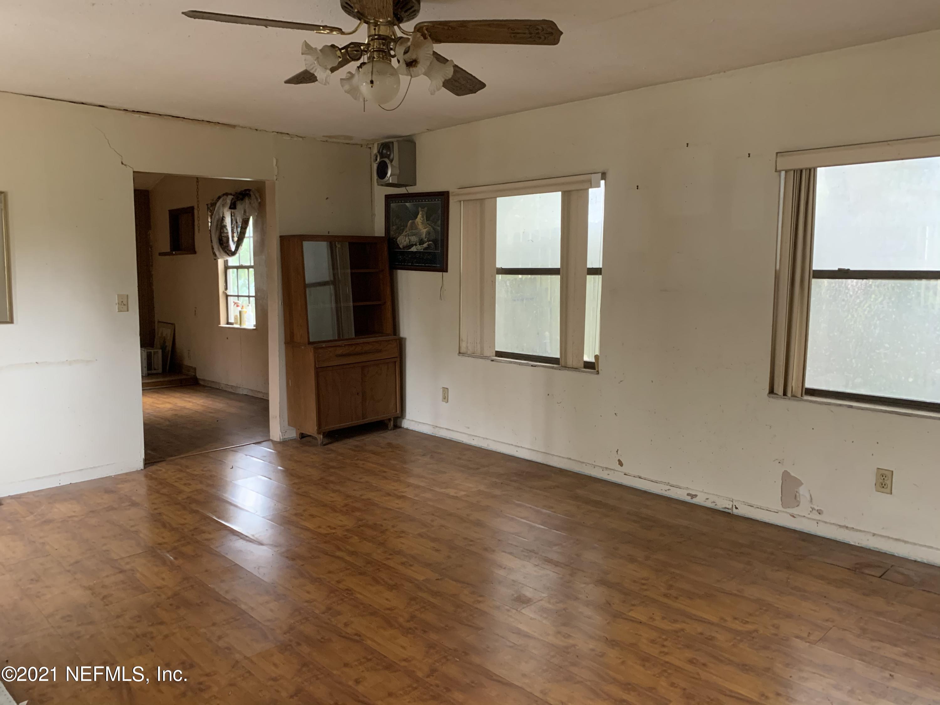 3852 Grant Road Jacksonville, FL 32207 - Photo 9 of 25 a view of empty room with wooden floor and fan